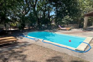 a large swimming pool with a red ball in it at Gîte du Jonquas in Velleron