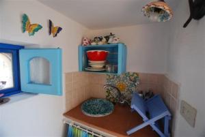 a kitchen with a counter with a blue cabinet at Zenzero canneto beach lipari in Canneto - Lipari