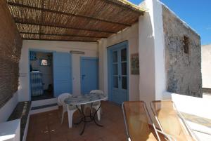 a patio with a table and chairs on a balcony at Zenzero canneto beach lipari in Canneto - Lipari