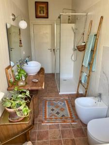 a bathroom with two sinks and a shower at Camera con bagno privato e terrazzo a 10 minuti dalla Stazione Centrale - Oasis Bologna Centro in Bologna +33 photos