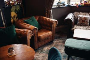 a living room with a leather chair and a table at The Station Restaurant & Bar in Doncaster