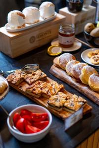 a table topped with bread and pastries and other foods at Cantina Semonte Wine Resort in Gubbio