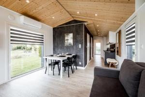 a dining room and living room with a table and chairs at Hundweiler Hofheimat in Markdorf