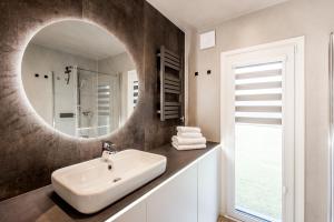 a bathroom with a sink and a mirror at Hundweiler Hofheimat in Markdorf