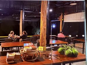 a group of people sitting at tables in a restaurant at kohrong sweet beach bungalows in Koh Rong Island