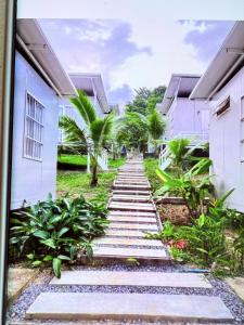 a walkway in front of a building with plants at kohrong sweet beach bungalows in Koh Rong Island +47 photos