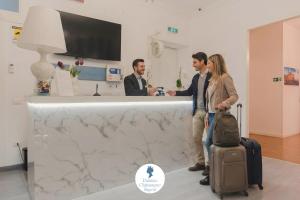 un gruppo di persone che si trovano a un bancone con bagagli di Palazzo Chiatamone a Napoli