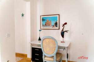 a desk with a chair and a desk with a bird on it at Stunning Holiday Home with Gorgeous Harbour Views in Senglea