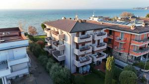 an aerial view of a building next to the water at Sirmio Apartments - Primavera Stay in Sirmione
