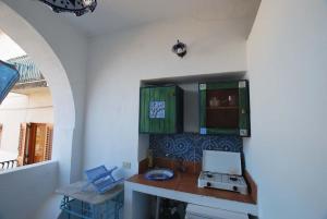 a kitchen with green cabinets and a counter top at Cannella studio flat Canneto Lipari in Canneto - Lipari