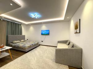 a bedroom with a bed and a couch in a room at Luxury Private Room near airport in Abu Dhabi