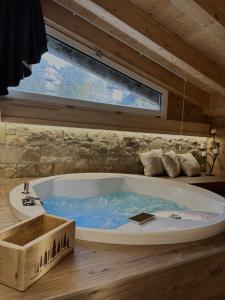 a large bath tub in a room with a window at Il giardino dei larici in Selvino