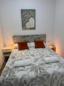 a bedroom with a large bed with orange pillows at Orange Suite By Alhaurín Loft City in Alhaurín de la Torre