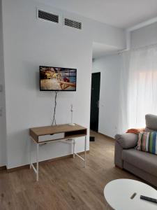 a living room with a couch and a table at Orange Suite By Alhaurín Loft City in Alhaurín de la Torre
