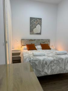 a bedroom with a bed and a table at Orange Suite By Alhaurín Loft City in Alhaurín de la Torre