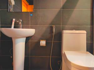 a bathroom with a sink and a toilet at Ivy Hotel Aromire in Hausa +29 photos