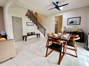 新邦安拨Charming 4BR Family House Quite Area & Cozy的带桌子和楼梯的客厅