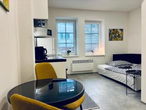 a small living room with a table and a bed at Apartmány Atrium in Litoměřice