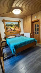 una camera con un grande letto in legno di Котеджі Цімбори a Yablunytsya Altre 127 foto