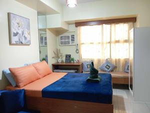 a bedroom with a bed and a couch and a window at Horizons 101 in Cebu City +27 photos