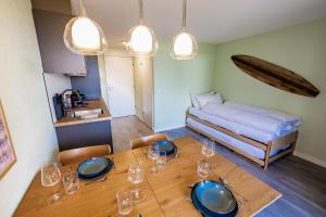 una sala da pranzo con tavolo e letto di Surfers Oase near Interlaken at lake with pool a Därligen