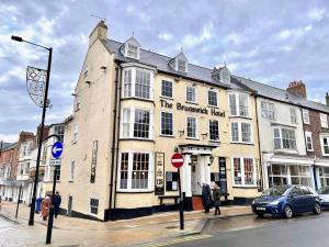 a large building on the corner of a street at The Brunswick Hotel in Bridlington +13 photos