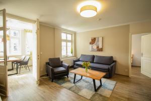 a living room with a couch and a table at Brise Villa Emmi App 04 in Heringsdorf