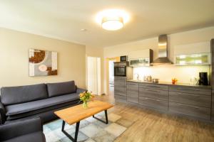 a living room with a couch and a table at Brise Villa Emmi App 04 in Heringsdorf
