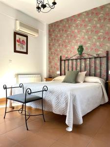 a bedroom with a bed with a floral wall at Hotel San Julian in Burunchel +74 photos