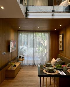 a living room with a table with dishes on it at Breezia Villa Mezzanine with Private Pool in Blimbing