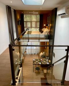 a staircase leading to a bedroom with a bed at Breezia Villa Mezzanine with Private Pool in Blimbing +1 photo