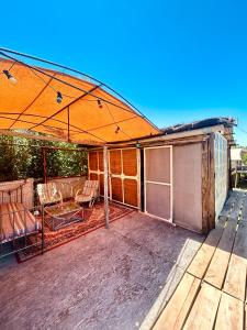 an enclosed patio with an orange roof on a house at Al Aire Libre in San Rafael +21 photos