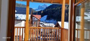 a view of a snowy mountain from a window at Apartment Weber in Nova Levante
