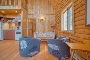 a living room with a chair and a table at Chalet Cerf for 16 Guests, 7 min to SPA, Skiing in Saint-Paul-de-Montminy +27 photos
