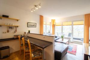 a living room with a fireplace and a table and chairs at Brise Haus "Am Schloonsee" App 05 in Bansin