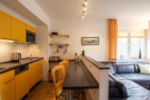 a kitchen and a living room with a couch at Brise Haus "Am Schloonsee" App 05 in Bansin