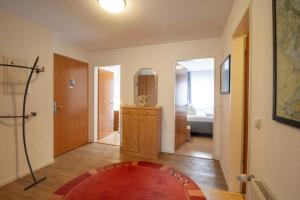 a hallway with a room with a mirror and a rug at Brise Haus "Am Schloonsee" App 05 in Bansin
