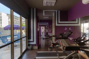 a gym with bikes in a room with purple walls at Studio Corcovado in Rio de Janeiro