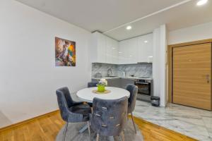 a kitchen with a table and chairs in a room at Vip Jovan 83 in Zlatibor