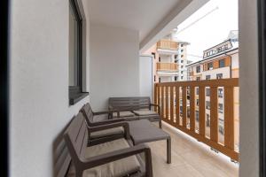 two chairs and a table on a balcony at Vip Jovan 83 in Zlatibor