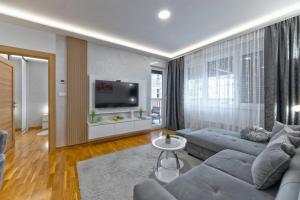 a living room with a couch and a tv at Vip Jovan 83 in Zlatibor +5 photos