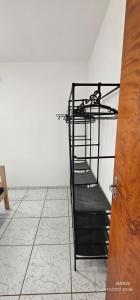 Ein Metalletagenbett in einem Zimmer mit Fliesenboden in der Unterkunft Apartamento 13 Balão, Paraquedas e Aventuras in Boituva