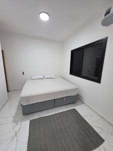 En eller flere senge i et værelse på Conforto, Balão & Paraquedas