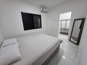 En eller flere senge i et værelse på Conforto, Balão & Paraquedas + 4 billeder