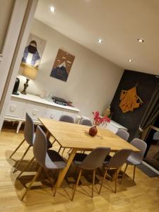 a dining room with a wooden table and chairs at Szczyt Wszystkiego in Szczyrk
