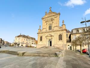 an old stone church with a large building at La maison peinte par Eugene Delacroix - Netflix in Cambrai