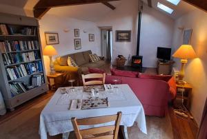 a living room with a table and a couch at Bryn Teg Barn in Dyffryn