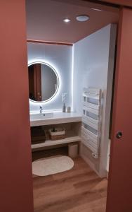 a bathroom with a sink and a mirror at Hôtel La SUITE & restaurant Le DÔME in Roanne +41 photos