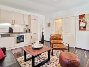 a living room with a table and a chair at Brise Villa Emmi App 03 in Heringsdorf