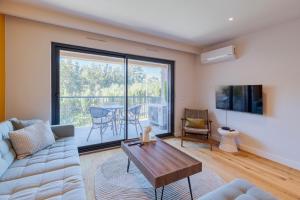 a living room with a couch and a table at Quinta View Apartment, By Home Match in Setúbal